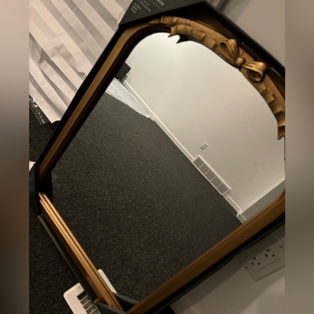 Gold bow mirror size is 18 x 24